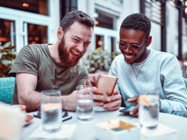 Swedish-Male-Laughing-While-Browsing-Social-Media-With-His-African-Friend-1184006408_8256x5504-800x533-1.jpeg